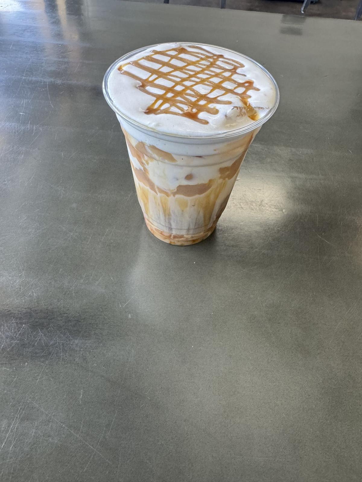 Iced caramel latte with a caramel drizzle lattice on top